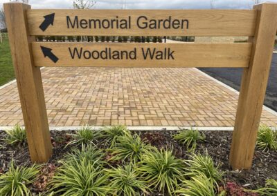 Image of memorial signpost to memorial garden or woodland walk
